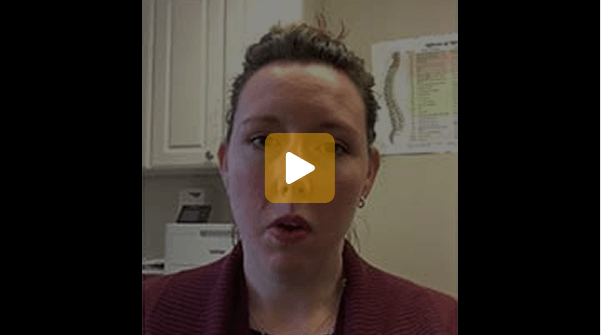 Video thumbnail of a woman speaking in an office, with a yellow play button centered on her face.